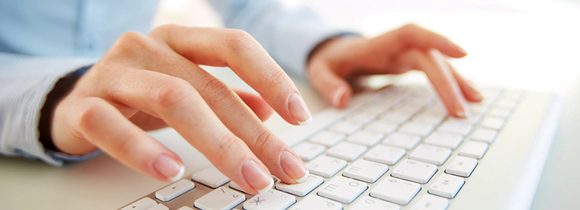 Hands typing on a keyboard for contact us